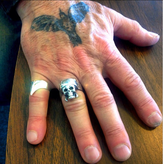 Bill Carter’s right hand, primarily the pirate skull ring given to him by close friend and fellow artist, Johnny Depp. Photo taken by the writer, Nicolette Mallow.